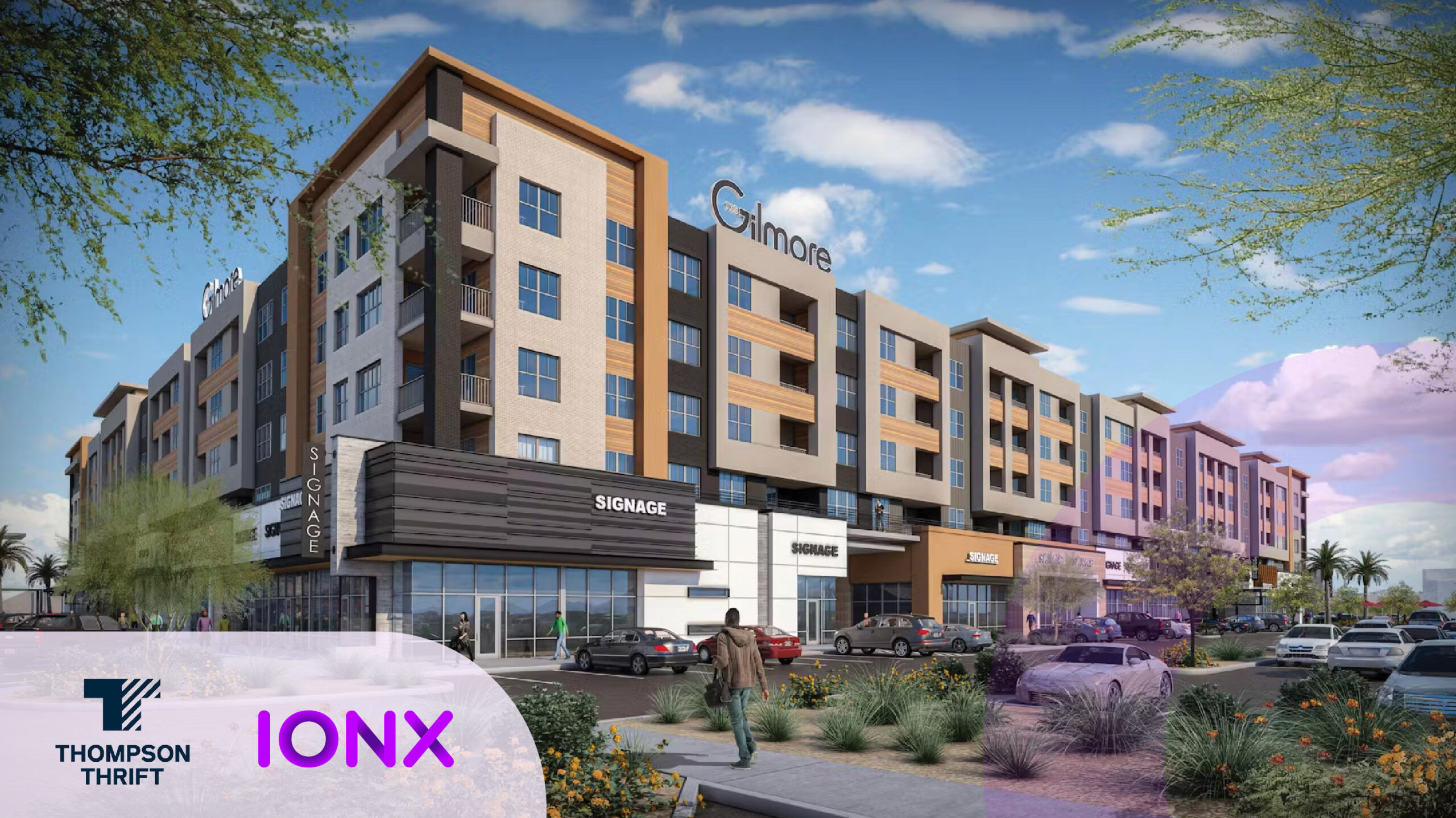 Modern apartment complex with parking lot, daytime view.